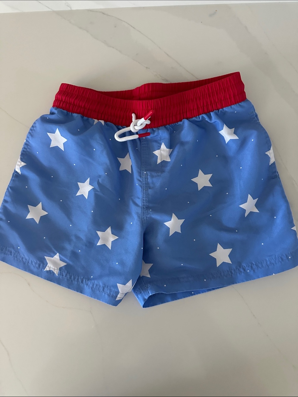 The Beaufort Bonnet Company boys Blue Star Print Shorts with Red Waistband.